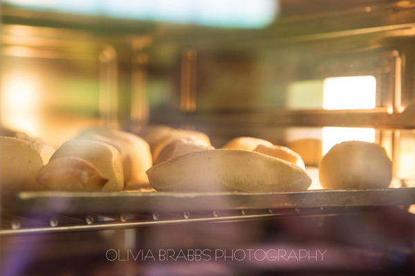bread rolls viewed through glass oven door