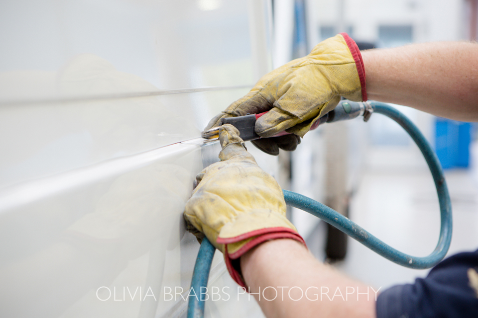 close up photograph of mechanics hands at work on van repair