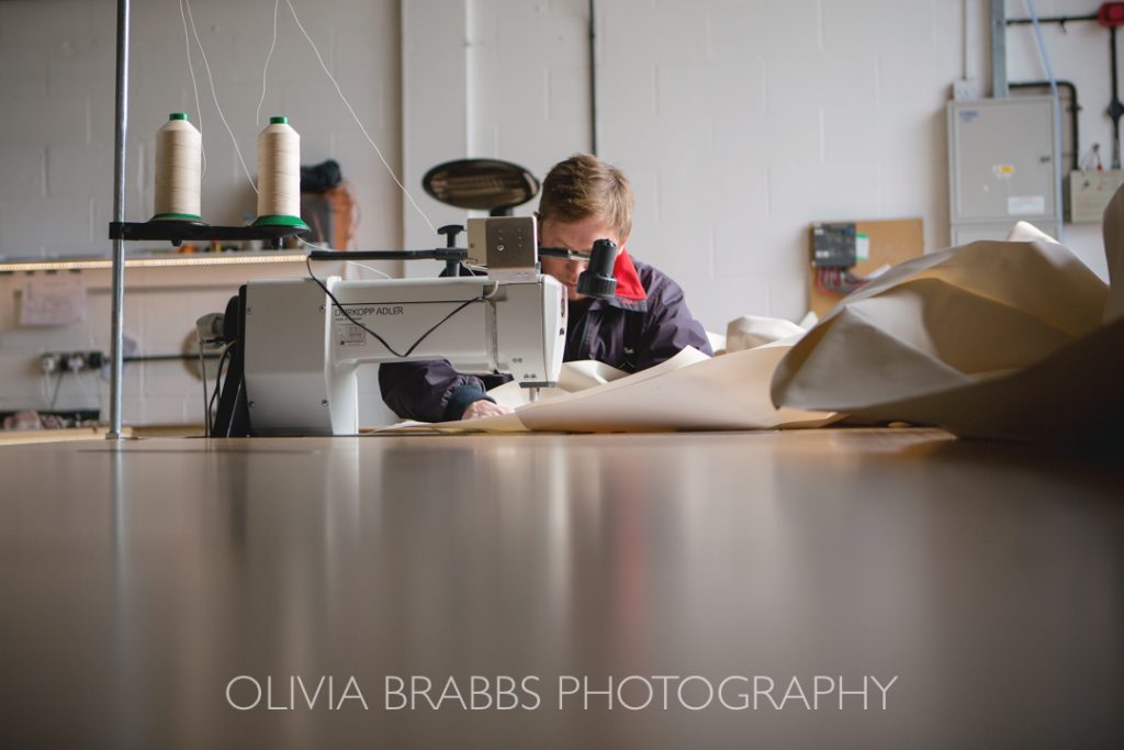 manufacturing photography for wills marquees in yorkshire showing sewing machine in action
