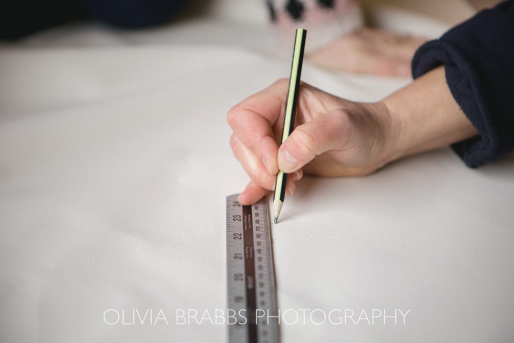 hand and ruler completing measurements for marquee production in yorkshire