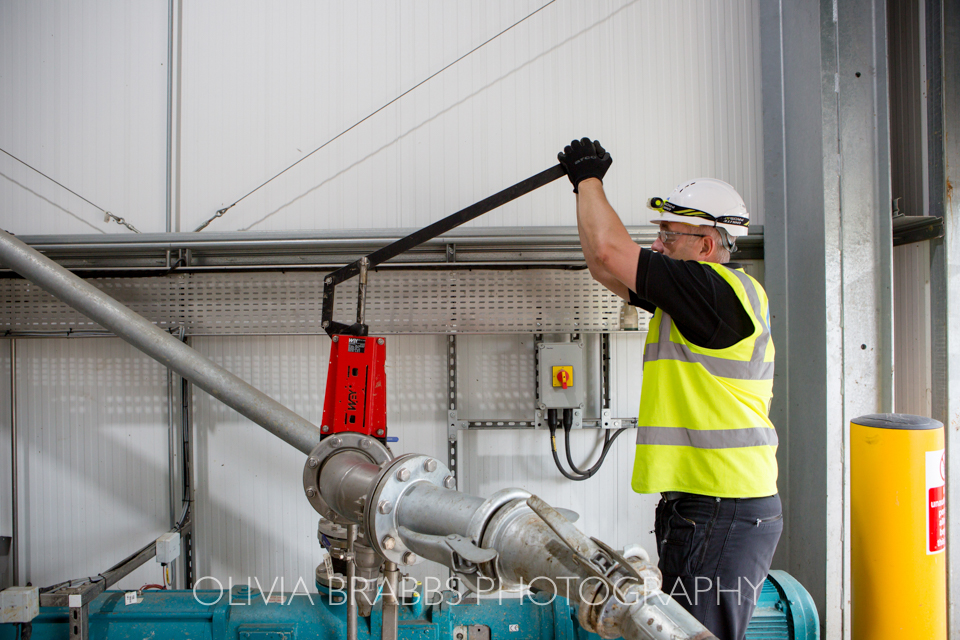 worker on industrial site pulling lever