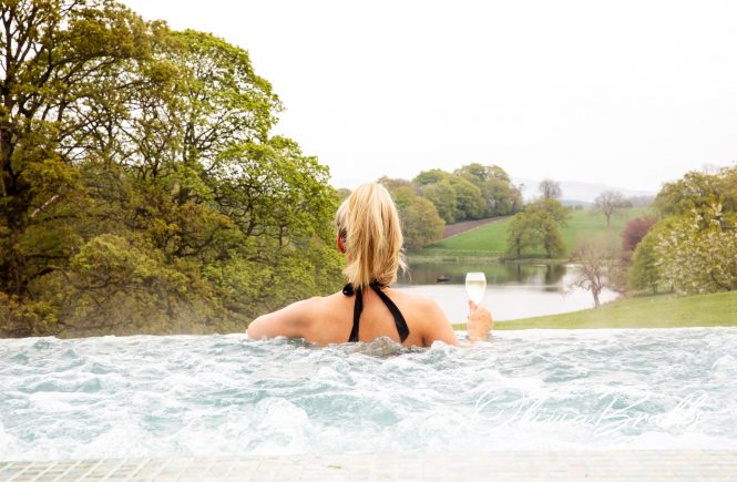 outdoor infinity pool with views of estate at the coniston hotel in north yorkshire