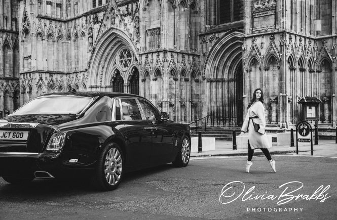 fashion photography at york minster featuring female model and ballerina in Jaeger clothes en pointe walking to rolls royce phantom