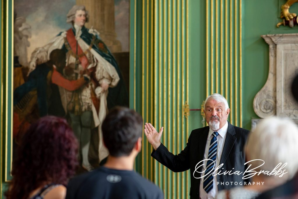 tour guide in stateroom talking to visitors at york mansion house