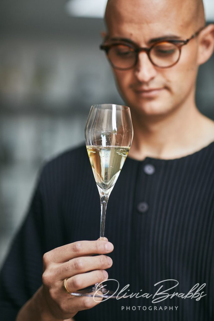 sommelier with glass of wine