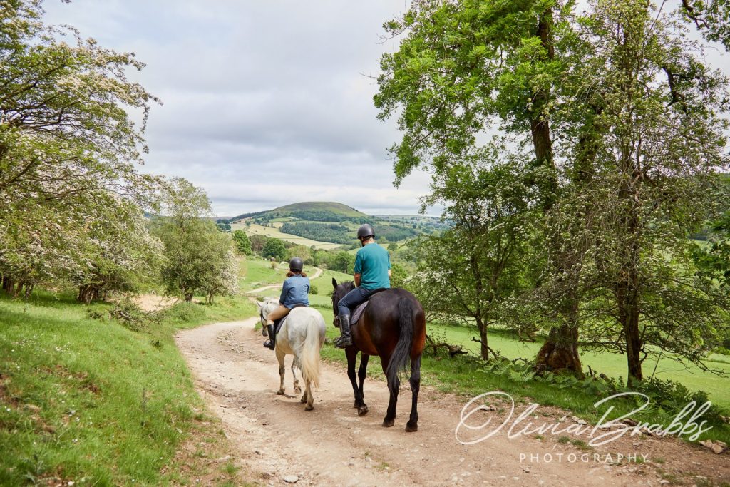 couple horse-riding in countryside near Helmsley in North York Moors National Park