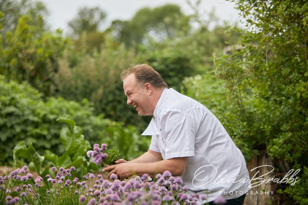 chef Andrew Pern collecting herbs in the garden at The Star at Harome