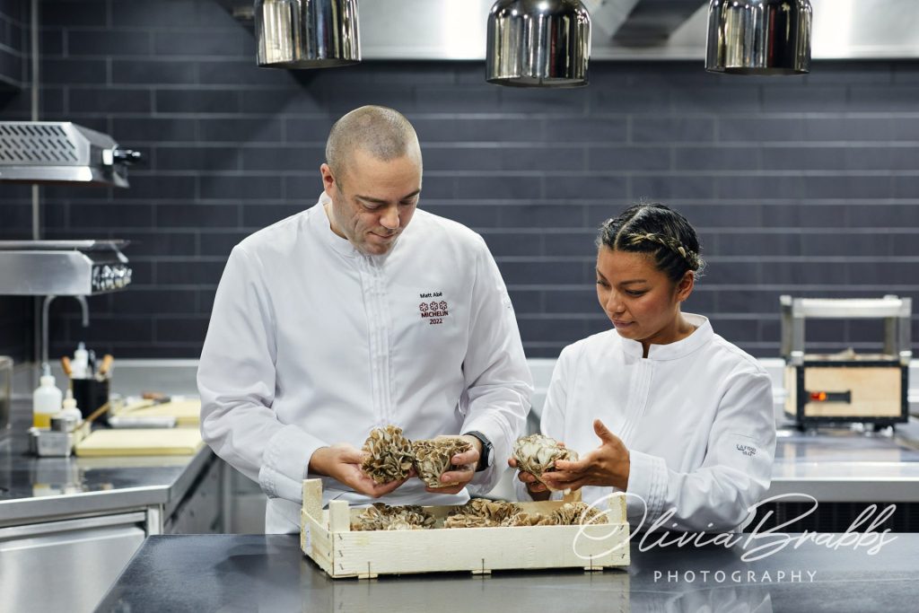 Chef Patron Matt Abé and Head Chef Kim Ratcharoen selecting produce in kitchen at Restaurant Gordon Ramsay London