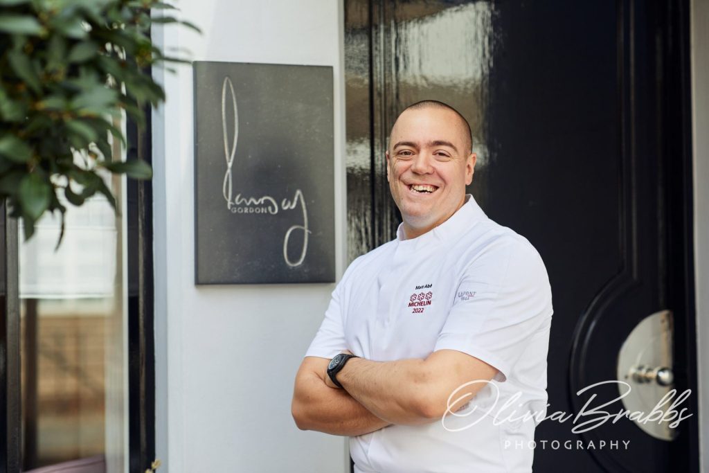 chef patron matt abé at front door of Restaurant Gordon Ramsay in London