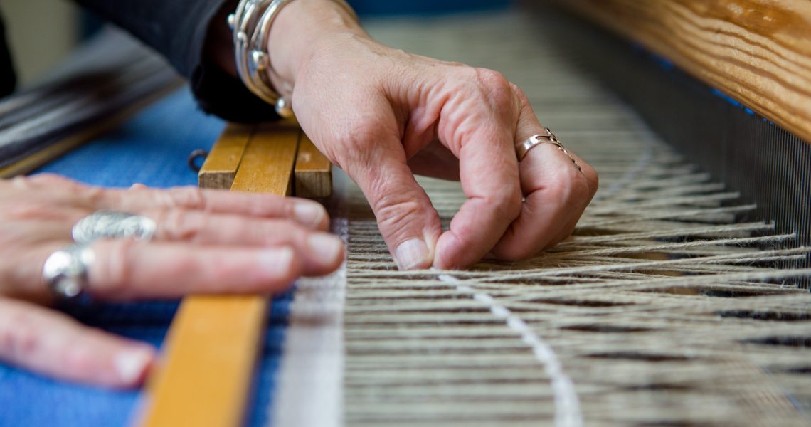 detail image of hands weaving